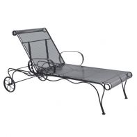 Woodard Tucson Commercial Adjustable Chaise Lounge featuring traditional curved ironwork and a durable mesh surface for a professional commercial setting.