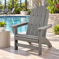 Grey POLYWOOD® Vineyard Grand Adirondack Chair styled on a stone patio next to an outdoor swimming pool.