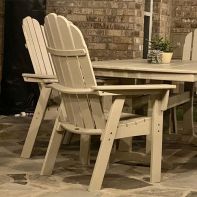 Front three-quarter view of the grey POLYWOOD® Nautical Curveback Adirondack Dining Chair, featuring an oversized seat, curved back slats, and a waterfall front on a white background.