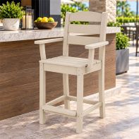 Off-white POLYWOOD Lakeside counter arm chair placed at an outdoor stone island bar counter